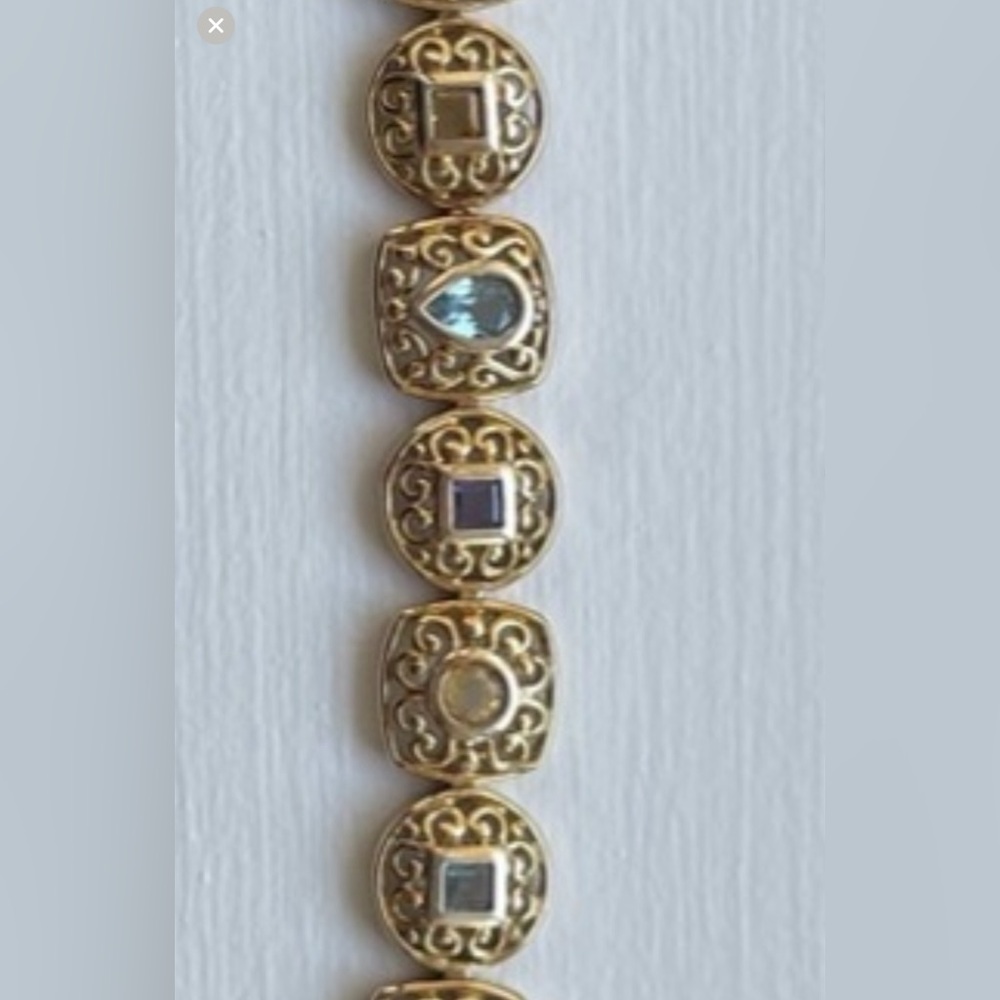 What a looker! Genuine stones set in a gold plated sterling silver bracelet
